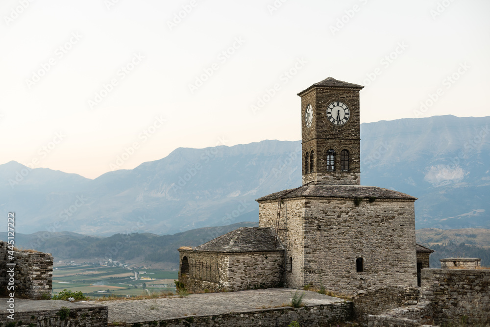 gjirokastra city in south albania. the most unique and tradional city with unique architechture. in the photo you can see the clock tower in the argjiro castle and the city in the background