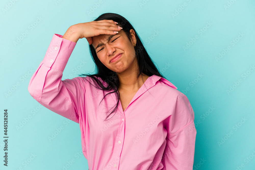 Young Venezuelan woman isolated on blue background touching temples and having headache. Young Venezuelan woman isolated on blue background touching temples and having headache.