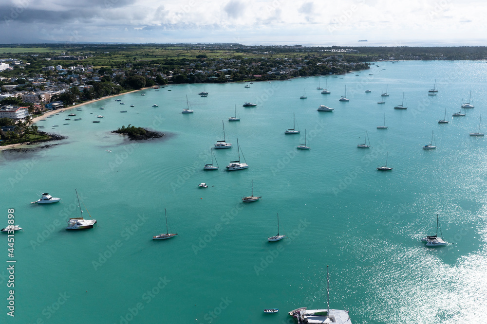 Obraz premium Aerial view, beaches with luxury hotels with water sports and boats at Trou-aux-Biches Pamplemousses Region, Mauritius, Africa