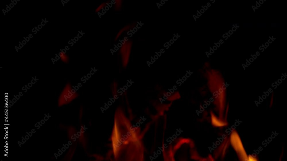 Abstractfire glowing particles on black background. Fire flames burning. Abstractfire glowing particles on black background. Fire flames burning.