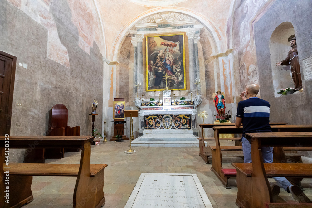 Italy. Caserta. A Catholic believer prays in a church.