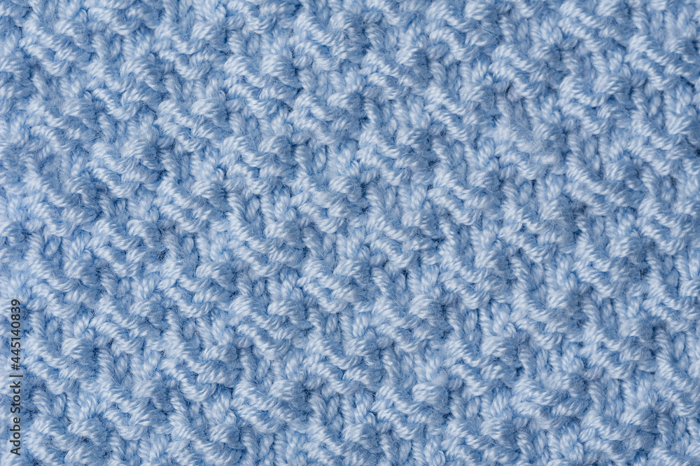 Obraz premium Knit texture of blue wool knitted fabric with pattern background.