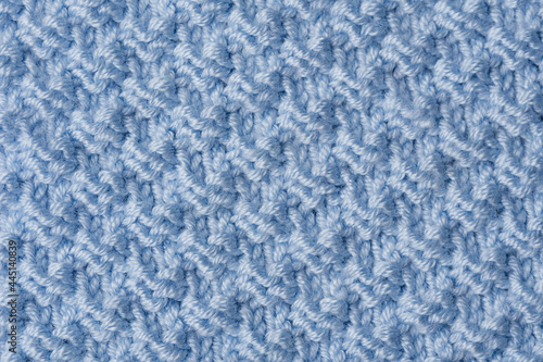 Knit texture of blue wool knitted fabric with pattern background.