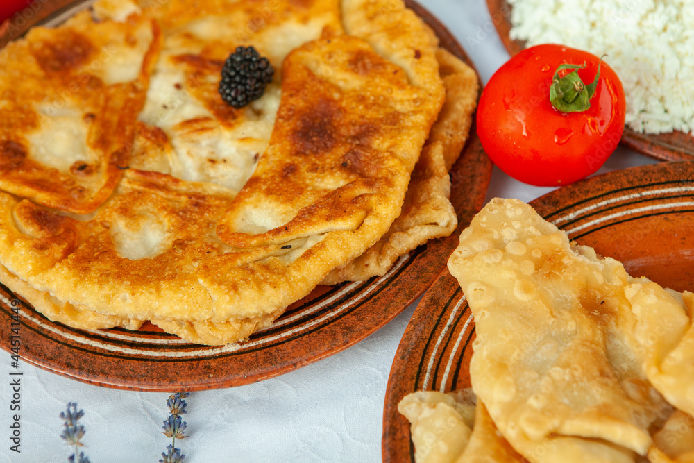 Traditional fried pies from Romania with potatoes, cheese and cabbage. Romanian food.
