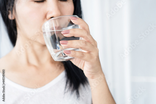 closeup thirsty Asian woman drinking water glass