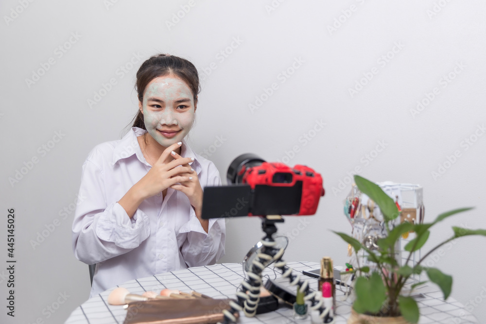 Head shot of a beautiful smiling woman with facial mask Head shot of a beautiful smiling woman with facial mask