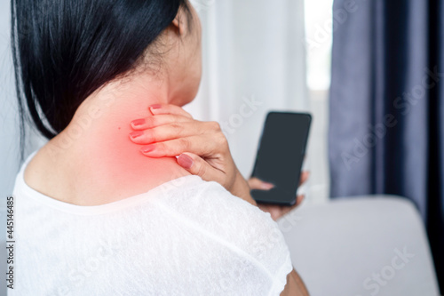 woman suffering from neck , shoulder pain using mobile phone too long with bad posture , internet addiction concept