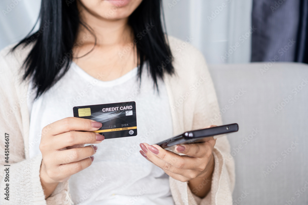 woman hand holding credit card and smart phone paying , shopping online, people with technology concept woman hand holding credit card and smart phone paying , shopping online, people with technology concept