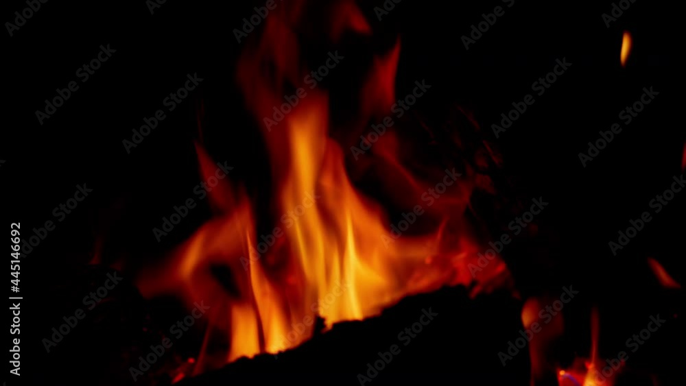 Embers rising fromfire on dark background. Flaming bonfire in night forest. Embers rising fromfire on dark background. Flaming bonfire in night forest.