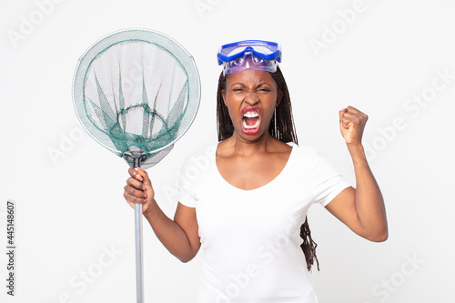 shouting aggressively with an angry expression with goggles and fisher net