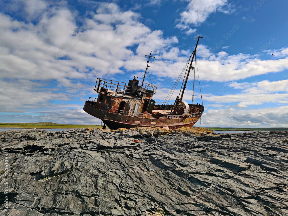 A fishing vessel thrown by a storm on the shores of the Barents Sea. - obrazy, fototapety, plakaty 