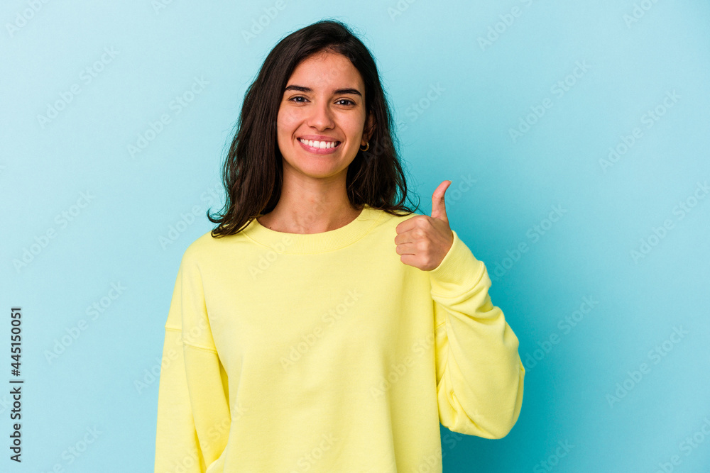 Young caucasian woman isolated on blue background smiling and raising thumb up Young caucasian woman isolated on blue background smiling and raising thumb up