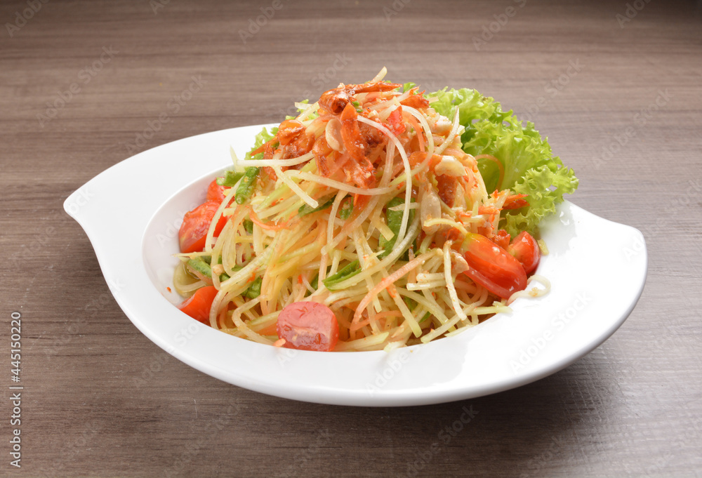 cold thai style spicy chilli sauce papaya and mango vegetable salad and shrimp in bowl on wood table asian Thai appetiser halal menu cold thai style spicy chilli sauce papaya and mango vegetable salad and shrimp in bowl on wood table asian Thai appetiser halal menu