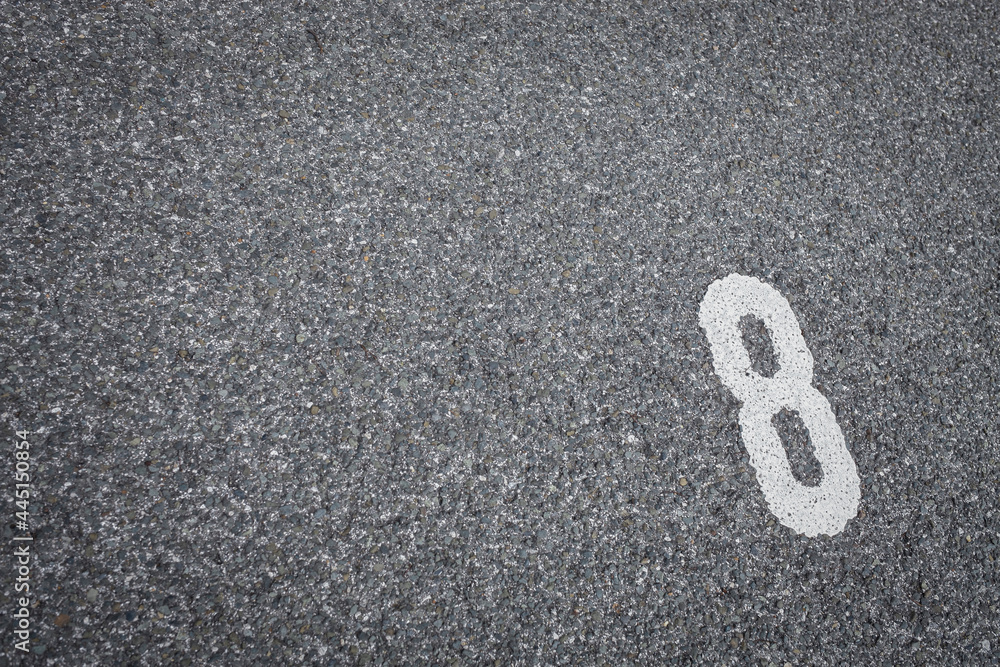 number eight white painted on grey street background number eight white painted on grey street background