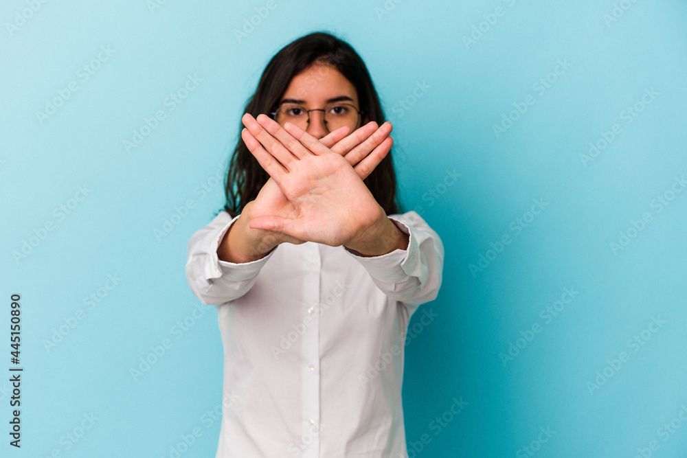 Young caucasian woman isolated on blue background doing a denial gesture Young caucasian woman isolated on blue background doing a denial gesture