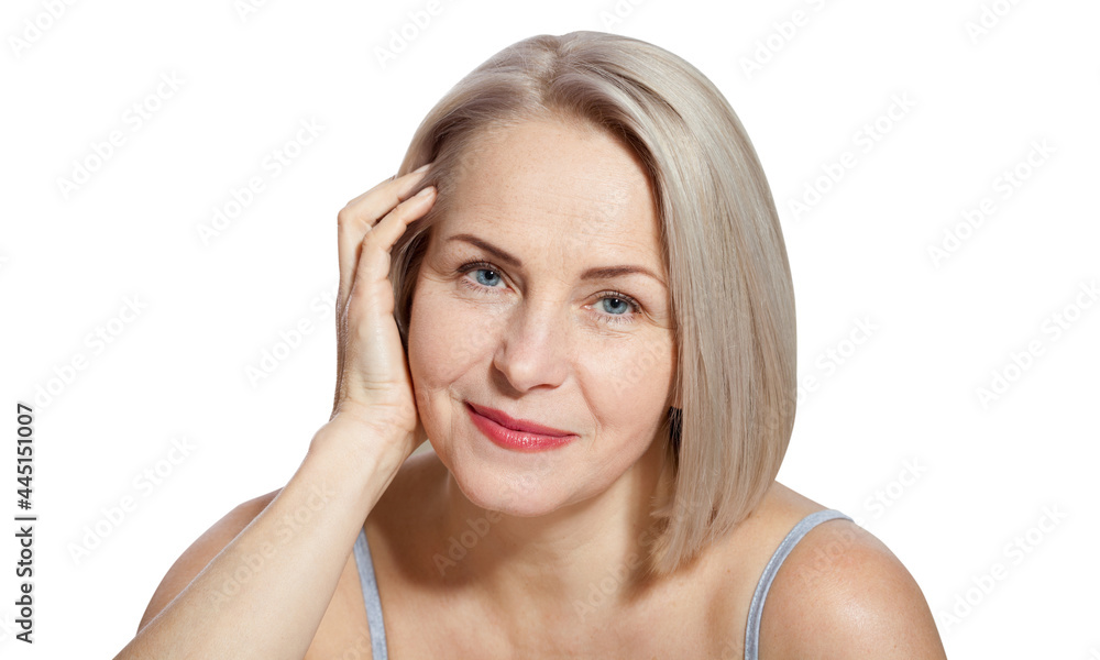 Beautiful middle-aged blonde woman shows off her perfectly well-groomed face. Macro face. Realistic images with their own imperfections.