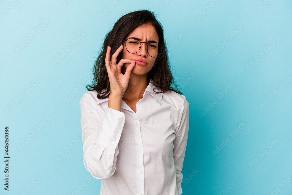 Young caucasian woman isolated on blue background with fingers on lips keeping a secret. Young caucasian woman isolated on blue background with fingers on lips keeping a secret.