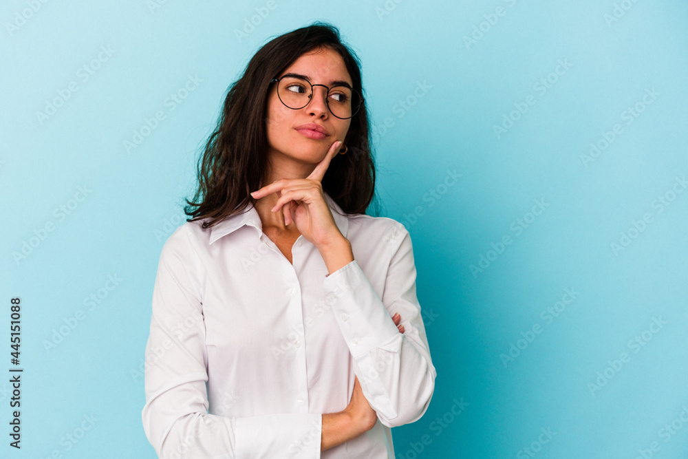 Young caucasian woman isolated on blue background contemplating, planning a strategy, thinking about the way of a business. Young caucasian woman isolated on blue background contemplating, planning a strategy, thinking about the way of a business.