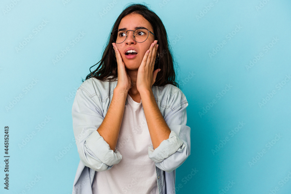 Young caucasian woman isolated on blue background scared and afraid. Young caucasian woman isolated on blue background scared and afraid.