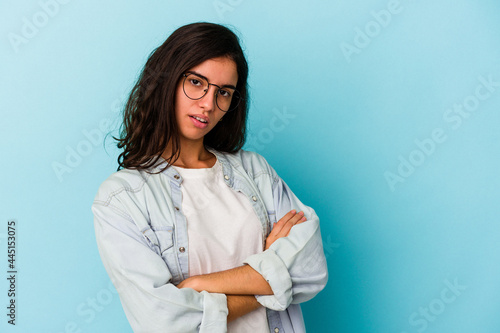 Young caucasian woman isolated on blue background who is bored, fatigued and need a relax day.
