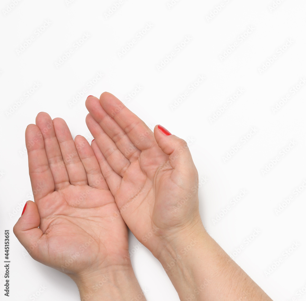 two female hands with red painted nails in a prayer pose on a white background two female hands with red painted nails in a prayer pose on a white background