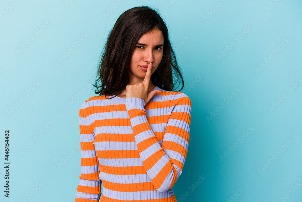 Young caucasian woman isolated on blue background thinking and looking up, being reflective, contemplating, having a fantasy. Young caucasian woman isolated on blue background thinking and looking up, being reflective, contemplating, having a fantasy.