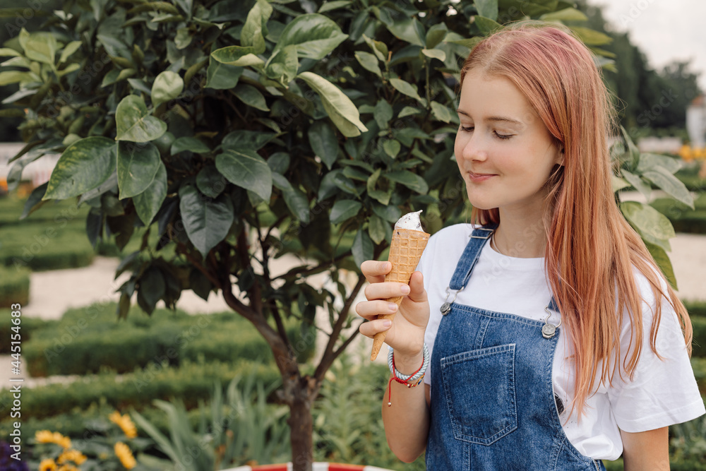 teenager girl in denim dress eating Ice-creamin hot summer day teenager girl in denim dress eating Ice-creamin hot summer day