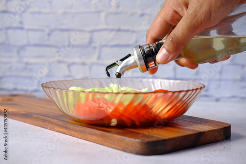 Pouring vegetable oil into a bowl close up 