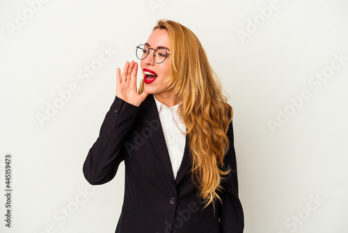 Caucasian business woman wearing a wireless headphones isolated on white background shouting and holding palm near opened mouth.