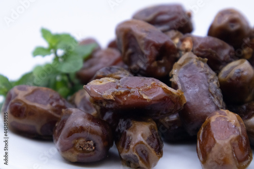 pile of dates with green leaf garnish