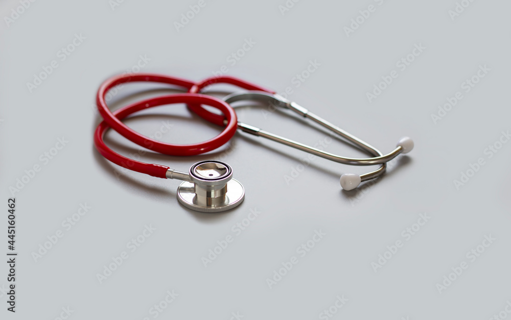 red stethoscope on gray background ,health care concept. red stethoscope on gray background ,health care concept.