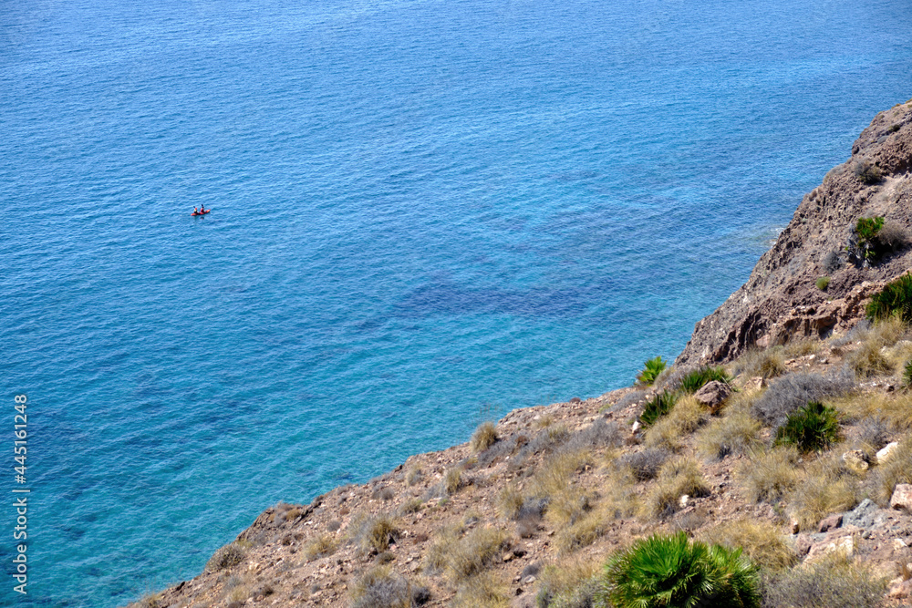 Cabo de Gata, Almeria, September 4, 2020, Kayak navigates the crystal clear waters of this Cabo de Gata-Nijar Natural Park, Mediterranean Sea, Andalusia, Spain