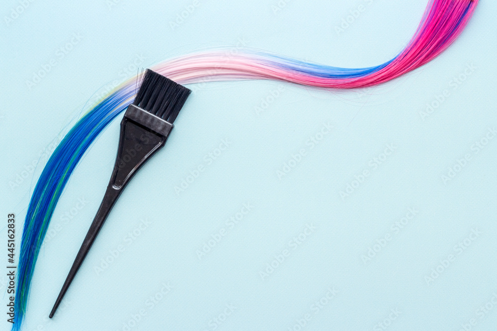 Brush and strand of coloring hair. Hair dye concept Brush and strand of coloring hair. Hair dye concept