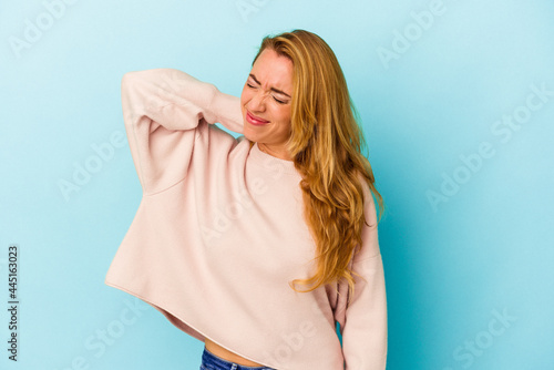 Caucasian woman isolated on blue background tired and very sleepy keeping hand on head.