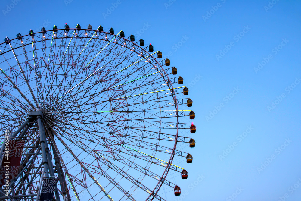 Huge Ferris Wheel with Lights against the Blue Sky Huge Ferris Wheel with Lights against the Blue Sky