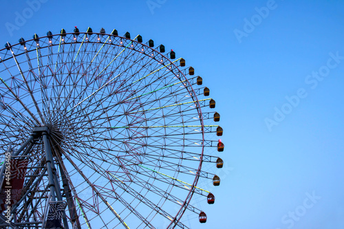 Huge Ferris Wheel with Lights against the Blue Sky