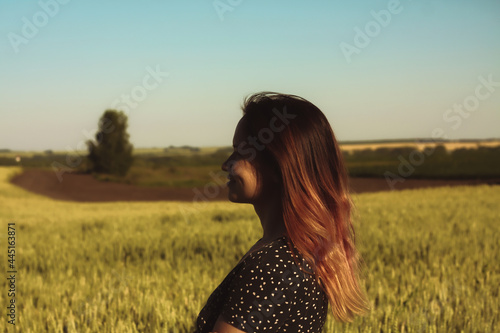 Russian girl in a field with wheat - here she is real freedom