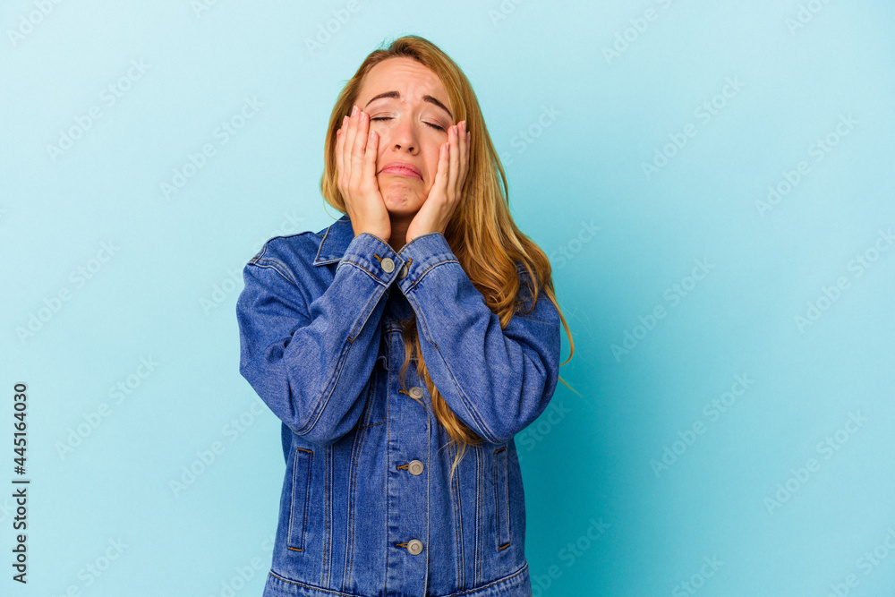 Caucasian woman isolated on blue background whining and crying disconsolately. Caucasian woman isolated on blue background whining and crying disconsolately.