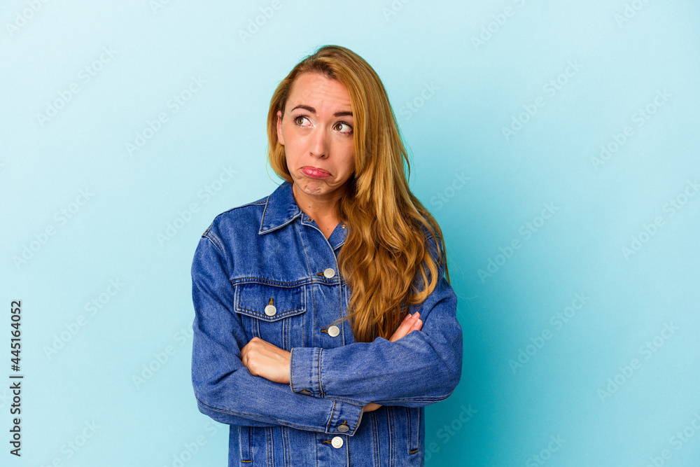 Caucasian woman isolated on blue background tired of a repetitive task. Caucasian woman isolated on blue background tired of a repetitive task.