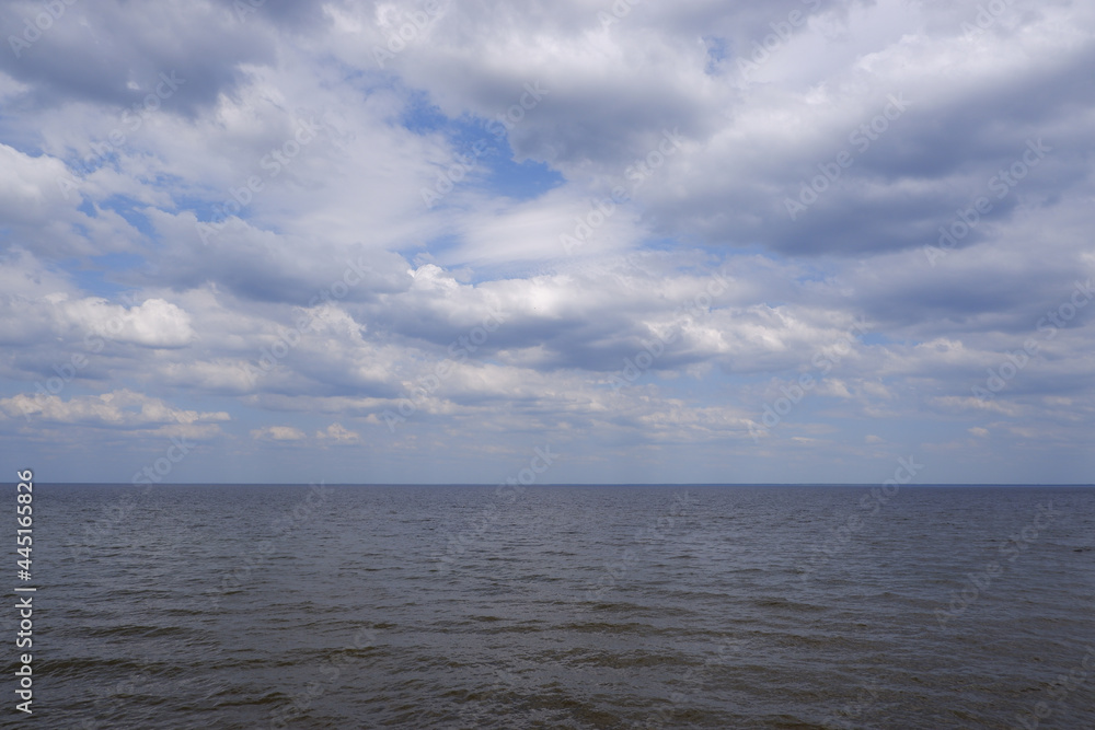 Scenery. View of the big river and the sky with clouds on a sunny day.