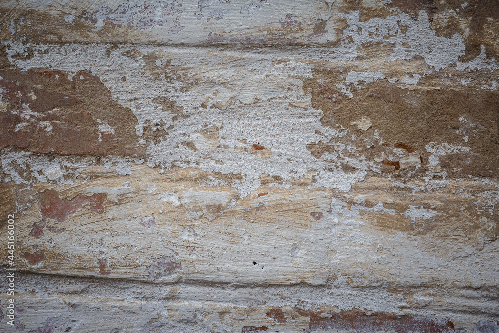 White painted old brick wall with red cracked bricks. White painted old brick wall with red cracked bricks.