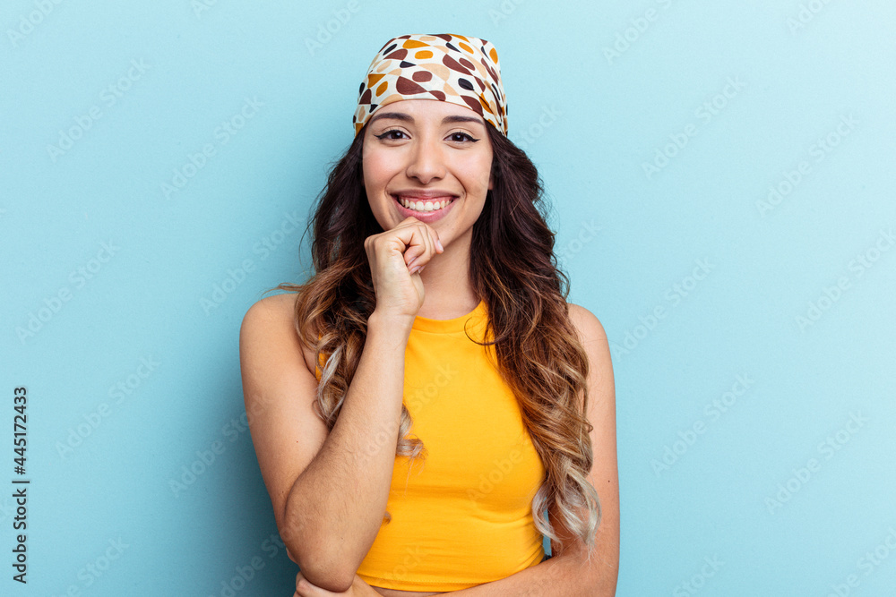 Young mexican woman isolated on blue background smiling happy and confident, touching chin with hand. Young mexican woman isolated on blue background smiling happy and confident, touching chin with hand.