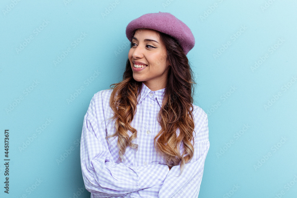 Young mexican woman isolated on blue background smiling confident with crossed arms. Young mexican woman isolated on blue background smiling confident with crossed arms.
