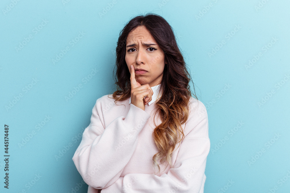 Young mexican woman isolated on blue background unhappy looking in camera with sarcastic expression. Young mexican woman isolated on blue background unhappy looking in camera with sarcastic expression.