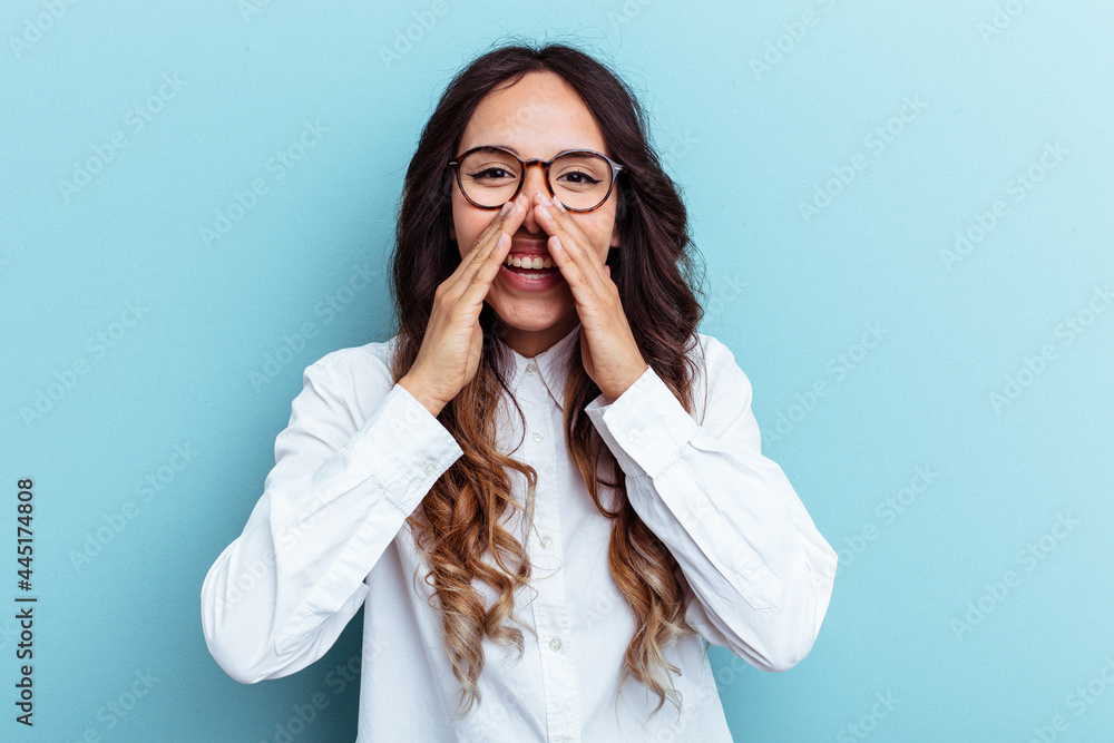 Young mexican woman isolated on blue background saying a gossip, pointing to side reporting something. Young mexican woman isolated on blue background saying a gossip, pointing to side reporting something.