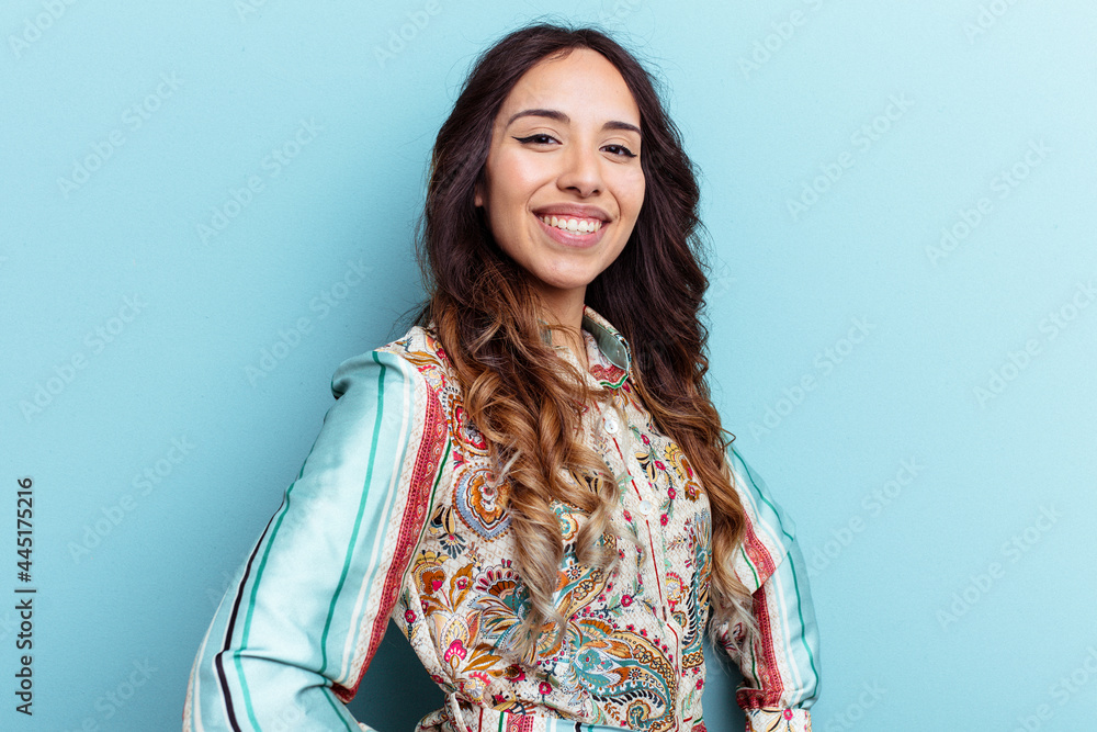 Young mexican woman isolated on blue background confident keeping hands on hips. Young mexican woman isolated on blue background confident keeping hands on hips.