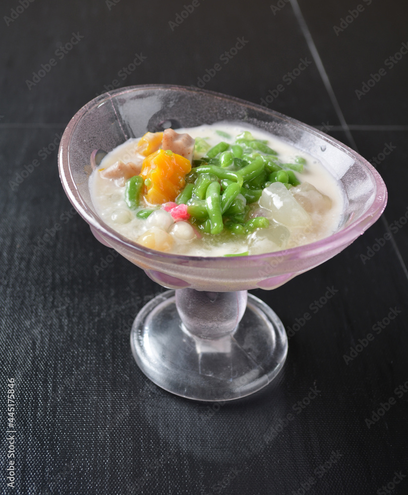 Thai style cold chendol bobo chacha green ruby dessert in glass on wood background asian dessert menu Thai style cold chendol bobo chacha green ruby dessert in glass on wood background asian dessert menu