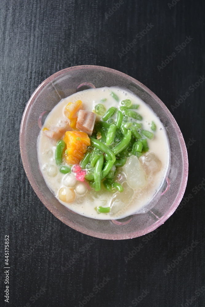 Thai style cold chendol bobo chacha green ruby dessert in glass on wood background asian dessert menu Thai style cold chendol bobo chacha green ruby dessert in glass on wood background asian dessert menu
