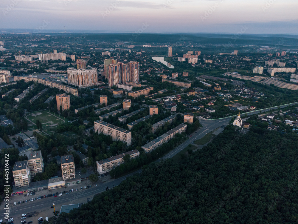 Aerial morning view Kharkiv city Pavlove Pole district Derevianka St. Multistory buildings new residential area near forest in summer dawn light