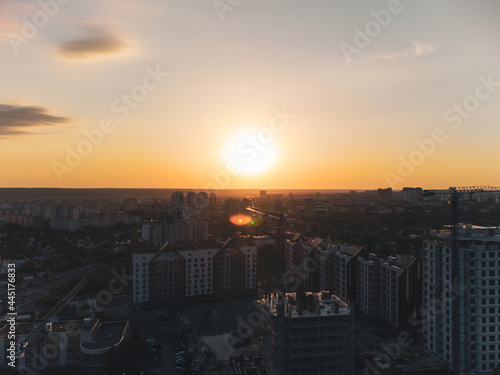 Aerial sunset view of Kharkiv city center new buildings near Park. Residential multistory houses with scenic dark moody sky